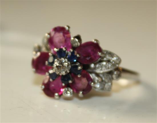 An 18ct white gold, diamond, sapphire and ruby flowerhead cluster ring, size O.